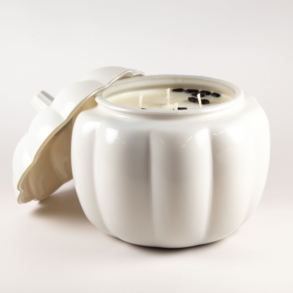 gray glass pumpkin vessel with a soy candle inside