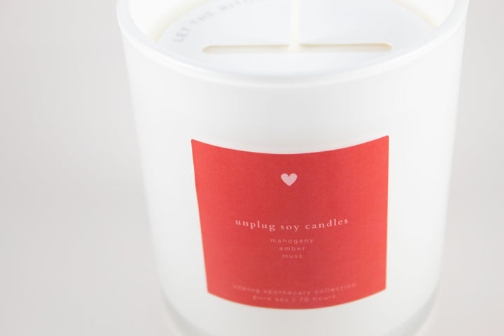 Candle with a red label on a white background